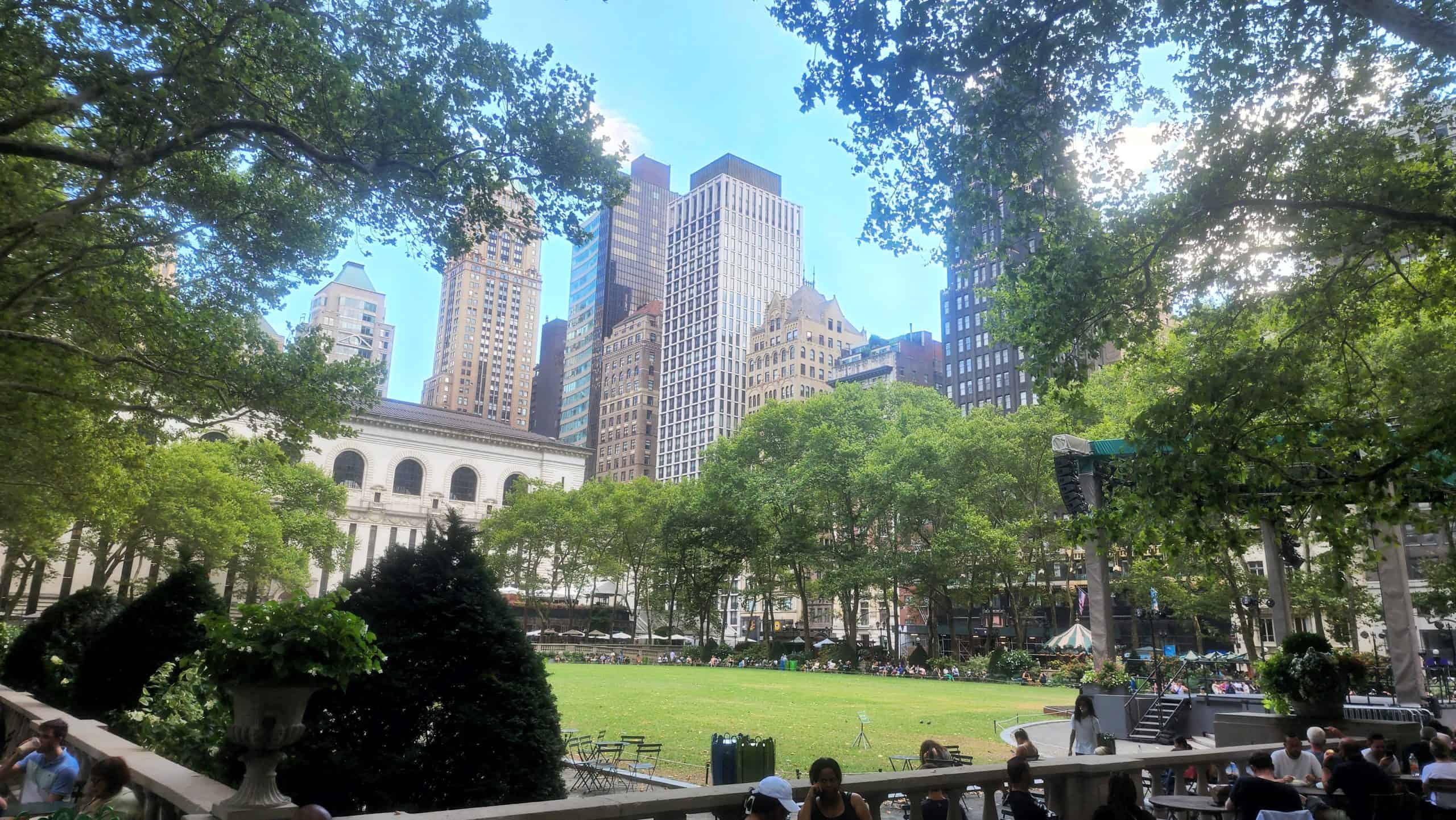 The New York City skyline emerges above a park.