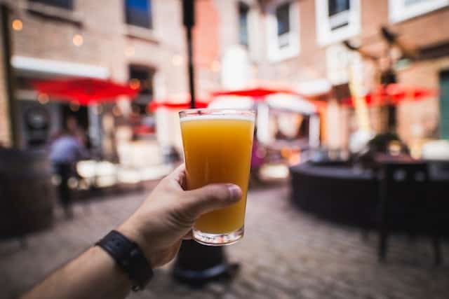 A person holds up a beer in New York City in October at Oktoberfest,.