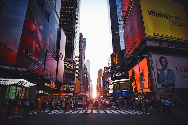 A large metropolitan street covered in billboards (Times Square).