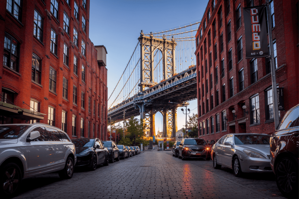 A view of a suspension bridge between two buildings. 