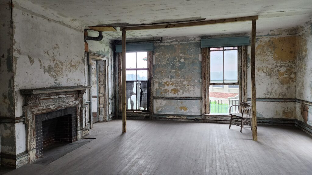 An old room in a ruined building that seems to be falling apart.