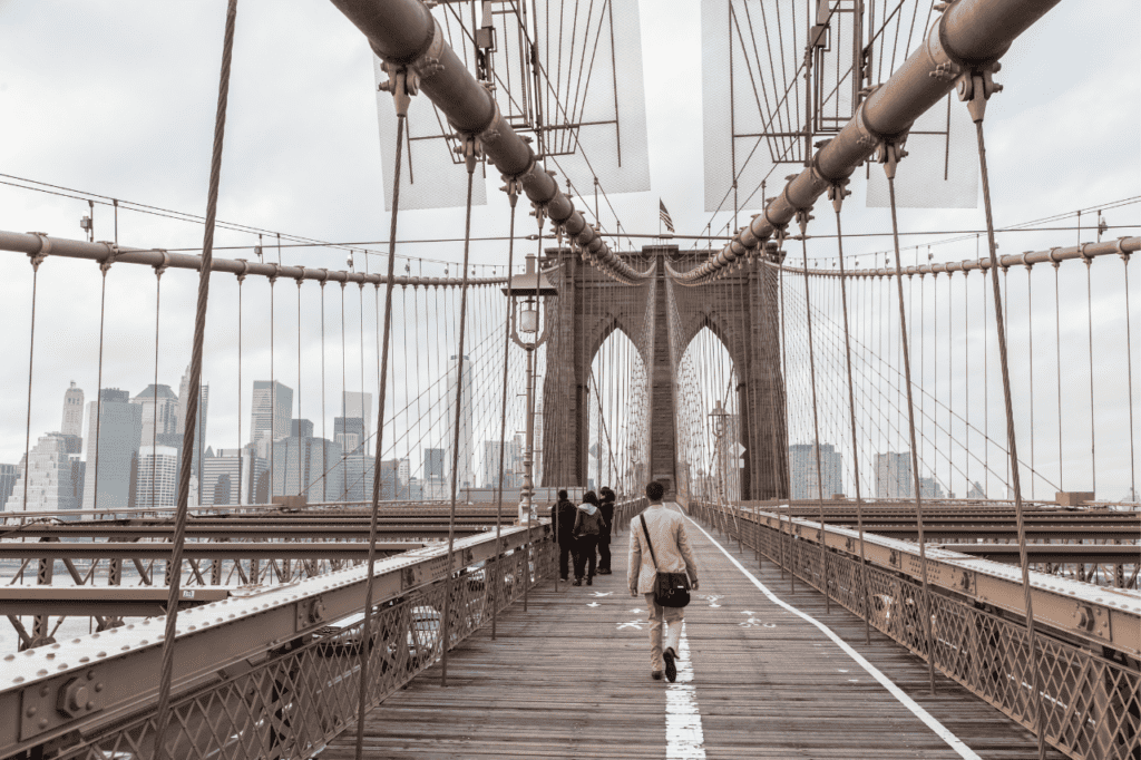 People walking across a suspension bridge.