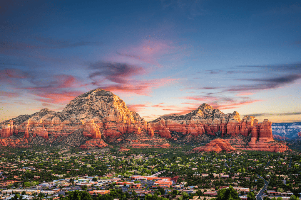 Majestic red rock mountain in Sedona, Arizona, basking in the warm glow of the setting sun. 