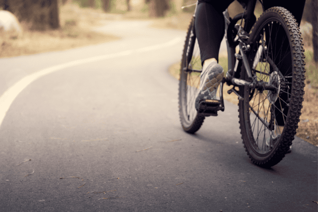 A close up of a bicycle on an asphalt road.