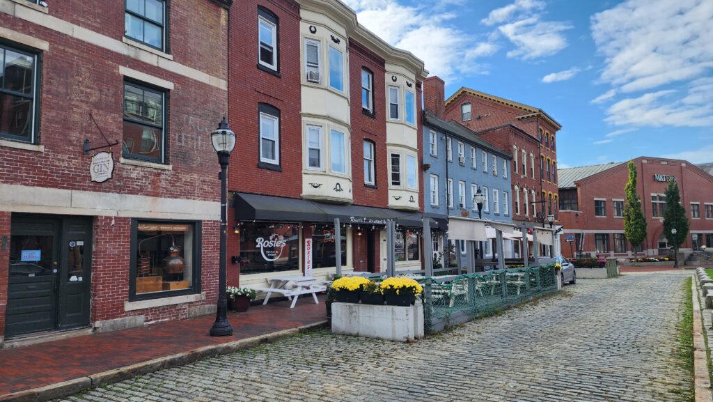 A historic square filled with brick buildings.