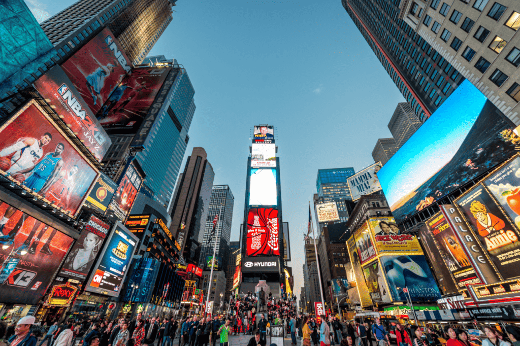 A bustling city center filled with bright billboards