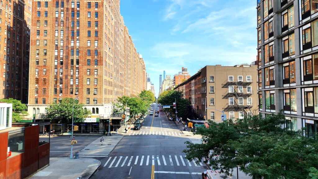 An intersection in a city filled with tall buildings.