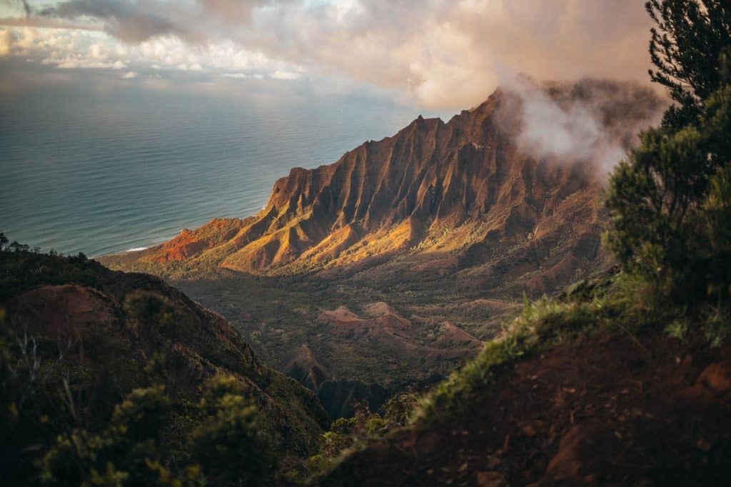 Jagged mountain rocks protrude from a tropical island.