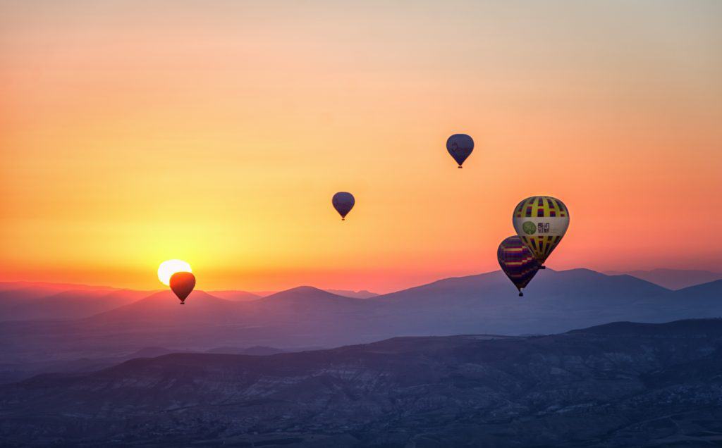 Hot air balloons in the sky during sunrise.