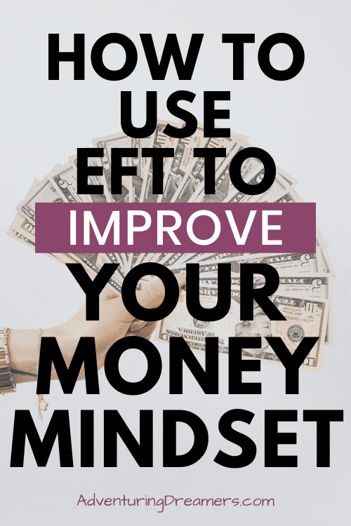 A hand holding out a fan of assorted money with a text overlay that reads: How to use EFT to improve your money mindset. Adventuringdreamers.com