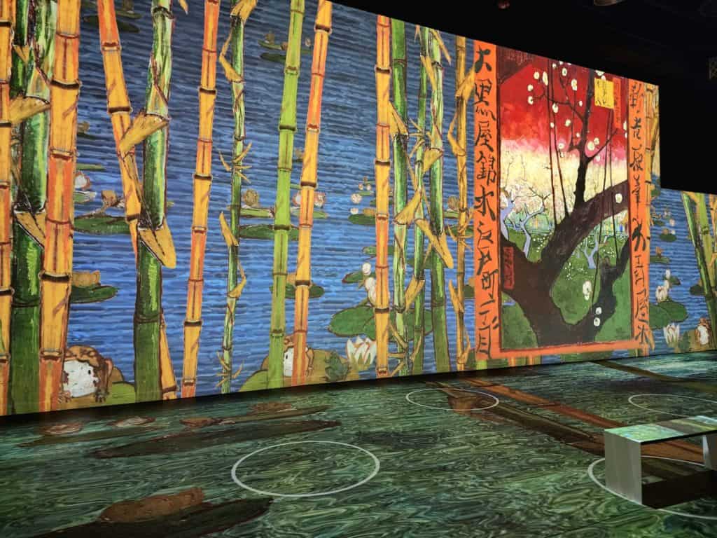 A bright colored Van Gogh painting in the Japanese style is projected onto the walls and floor.