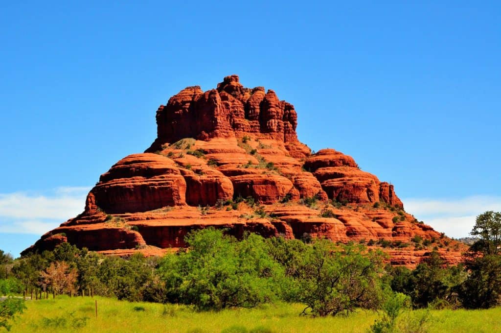 A red rock mountain against a blue sky