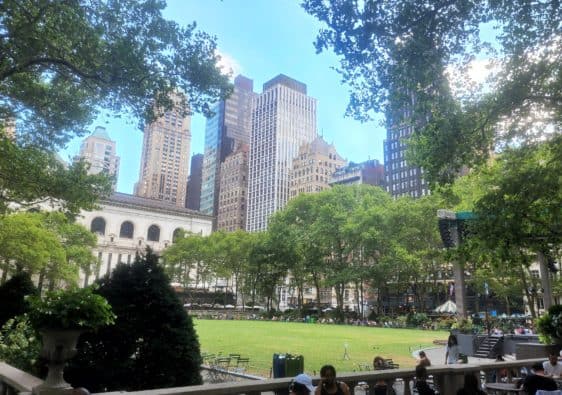 The New York City skyline emerges above a park.