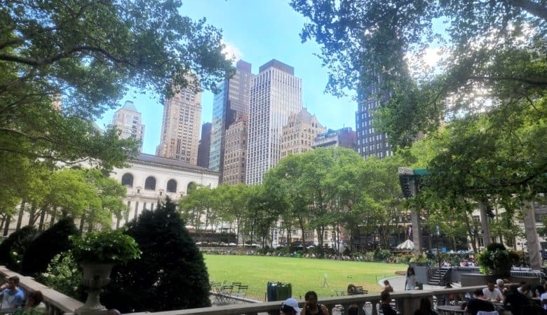 The New York City skyline emerges above a park.