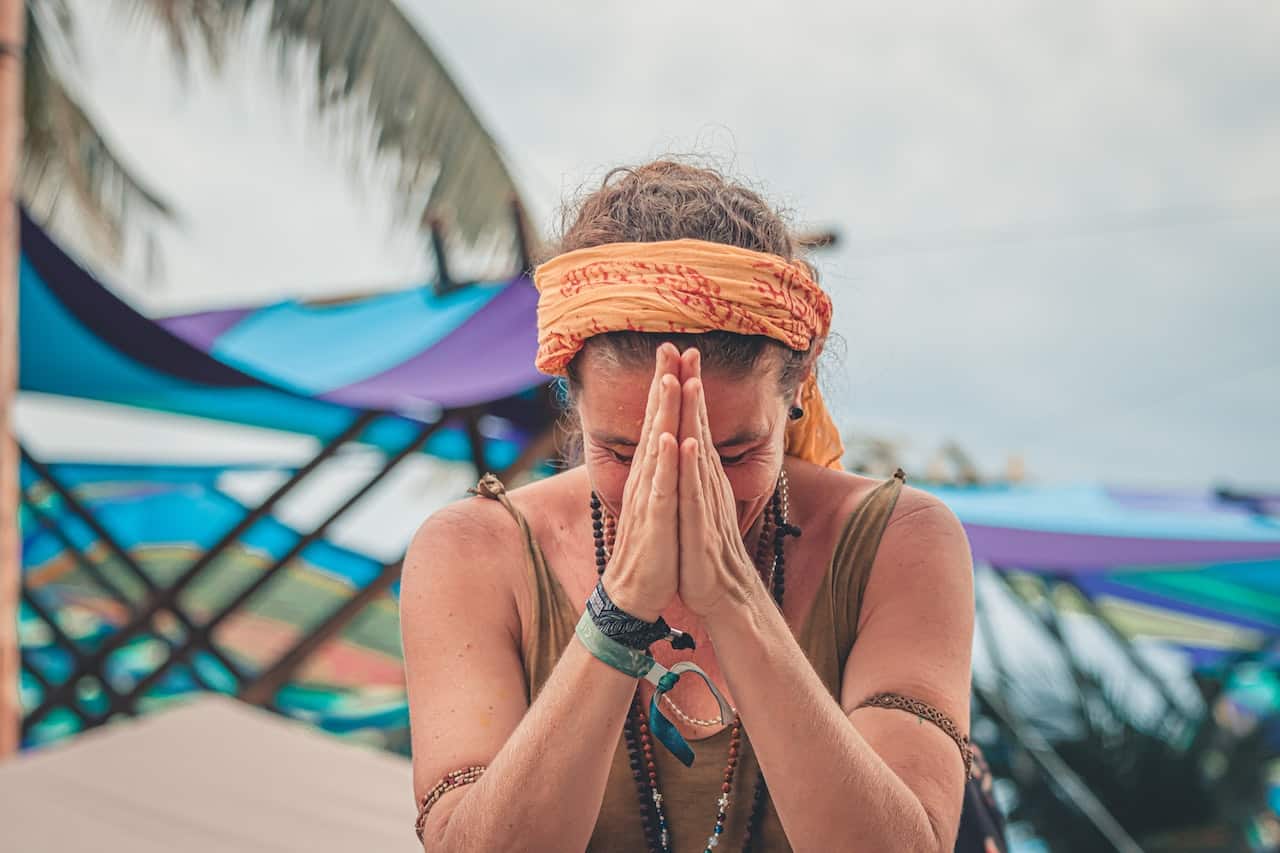 A woman bows her head to her hands