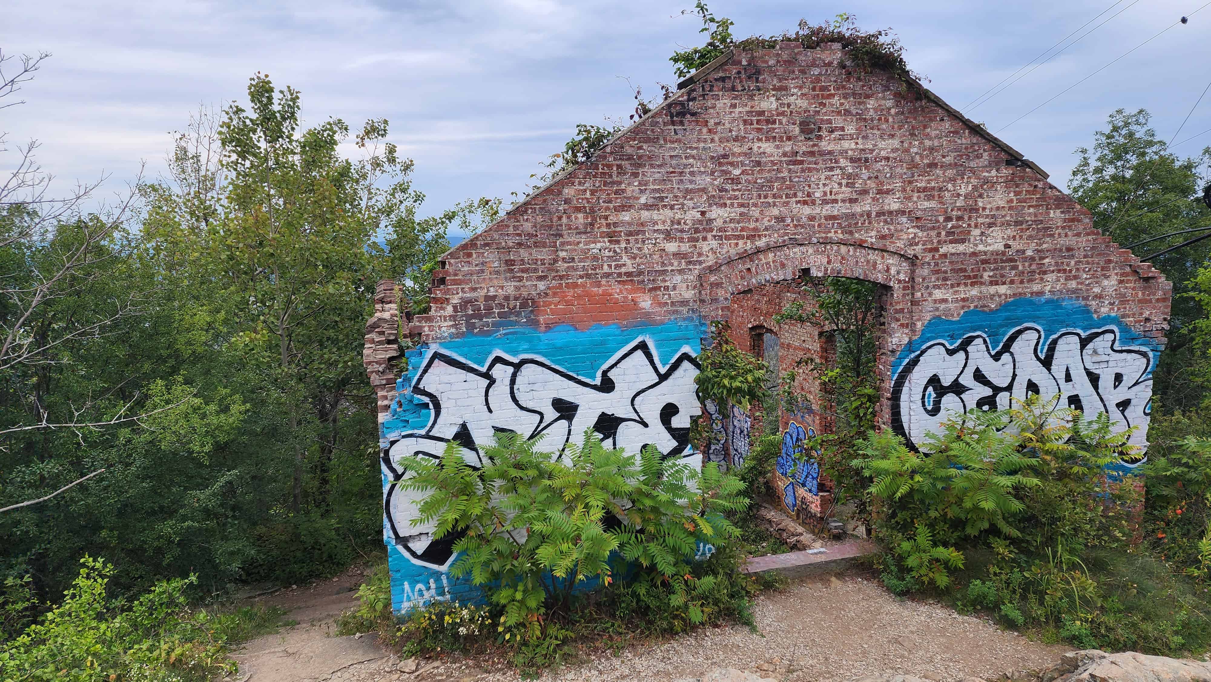 A ruined building covered in graffiti.