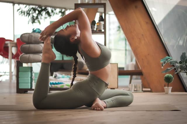 A woman does a back-bending yoga pose.