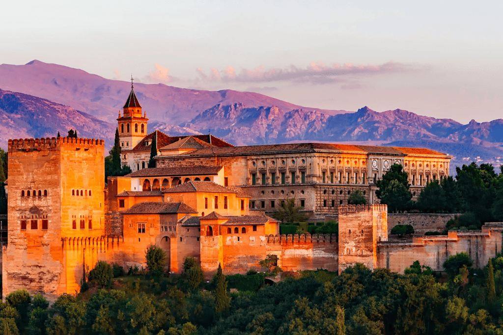 A grand palace shines in the orange light of sunset.