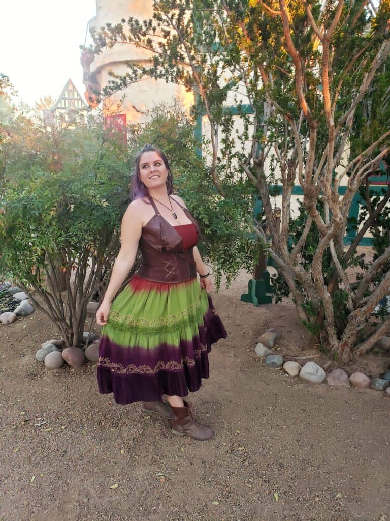 A woman dressed for a Renaissance Fair poses for the camera.