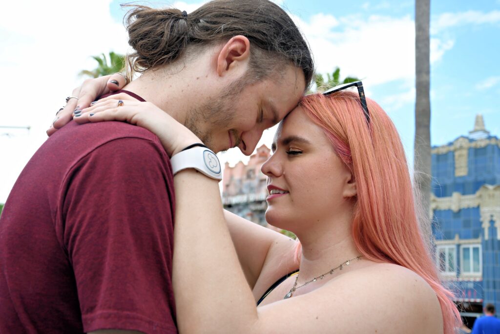 A woman and man lean their foreheads together in a moment of romance.