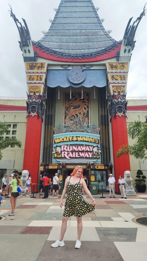 A woman poses in front of the Chinese Theater, one of the best photo spots at Disney's Hollywood Studios.