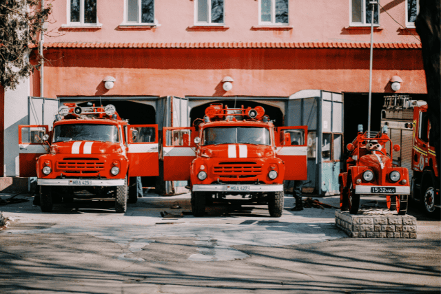 Three fire trucks parked at the station.
