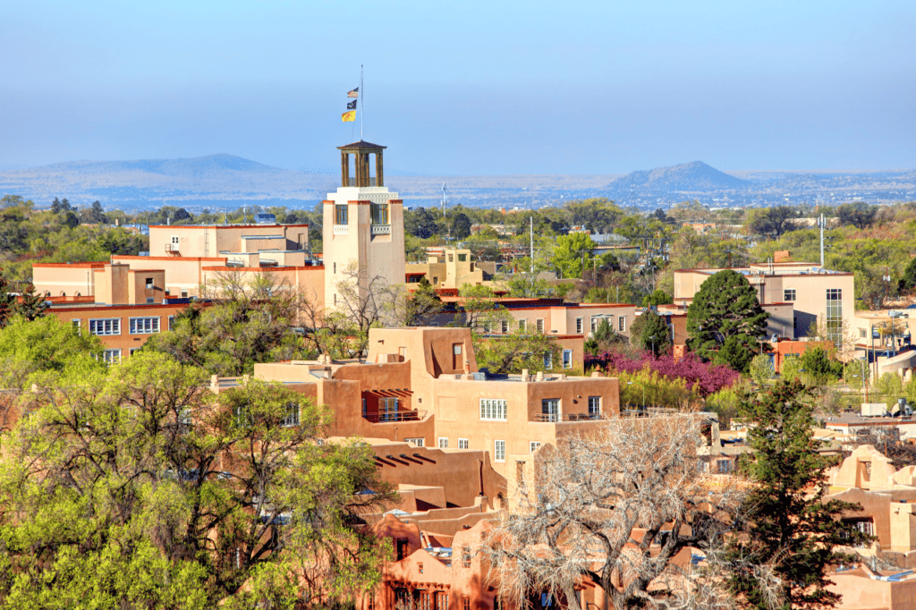 Birds eye view of a desert city made of Pueblo-Spanish Revival buildings.