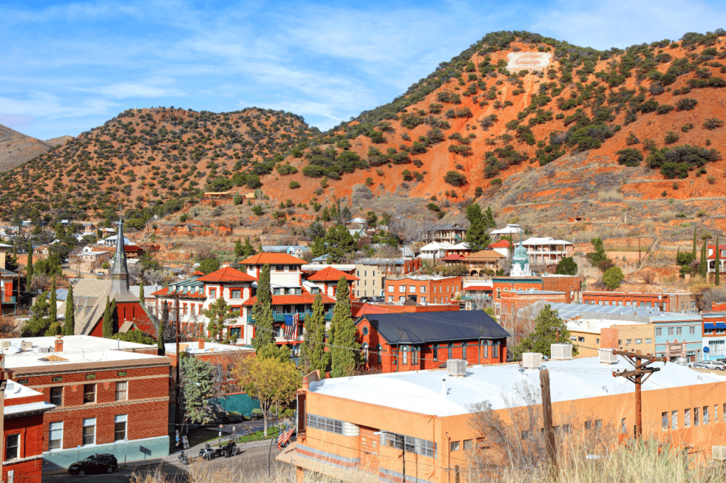 A western town built near red rock mountains.