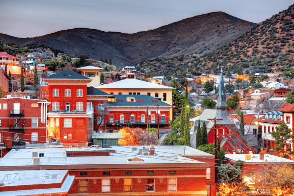 A western town is nestled at the foot of a mountain