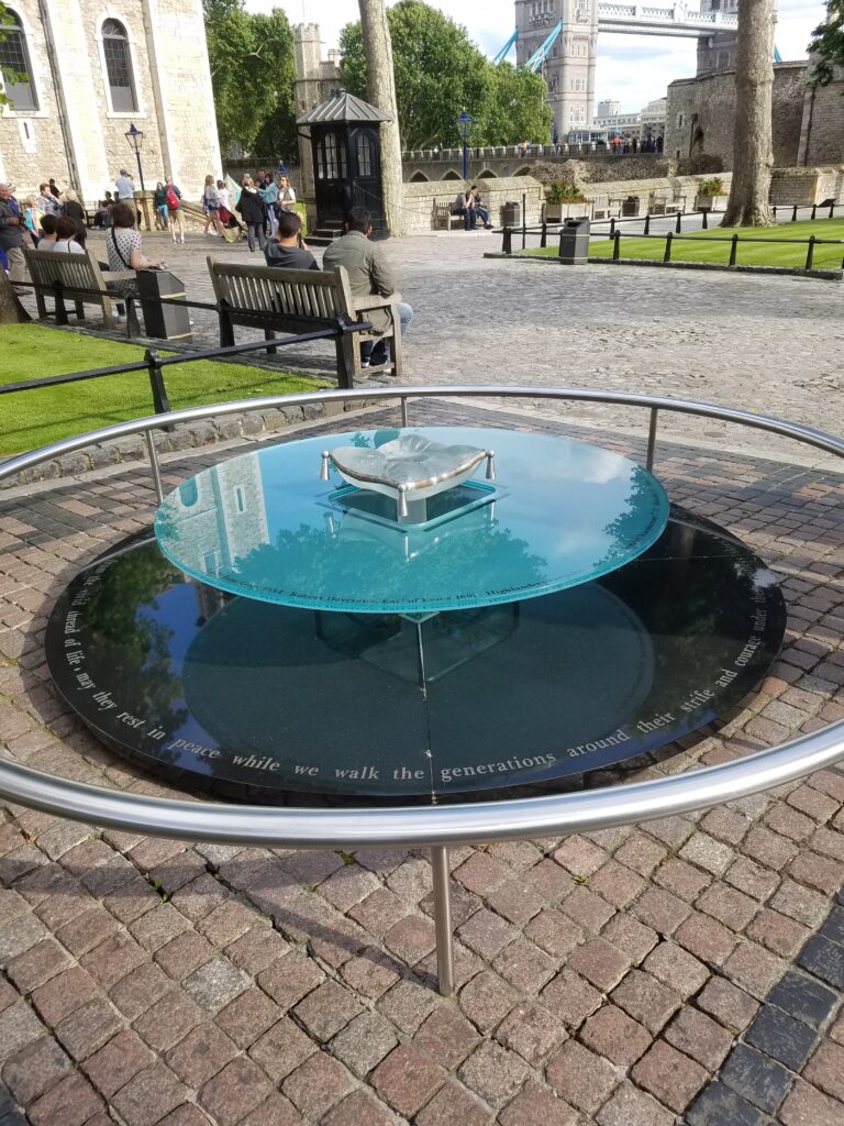 A circular glass memorial.