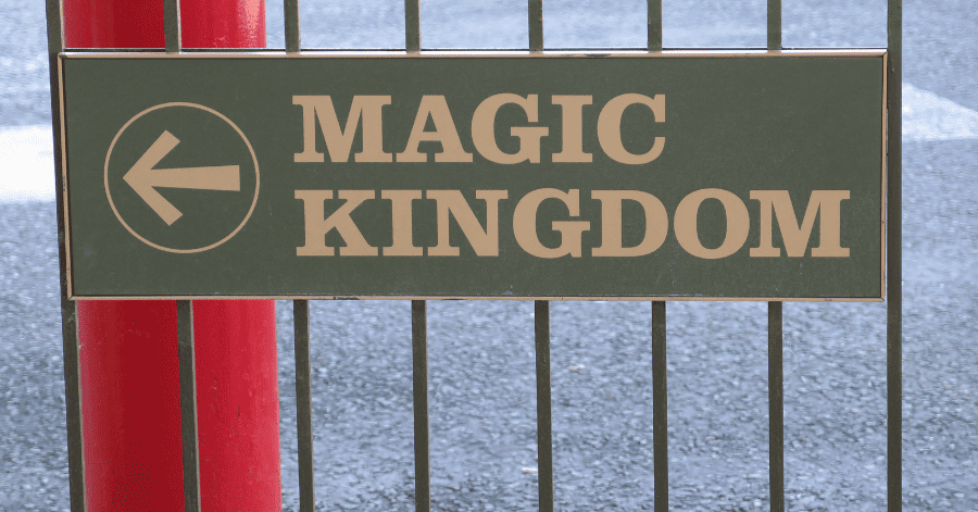 A sign reads "Magic Kingdom" with an arrow pointing left.